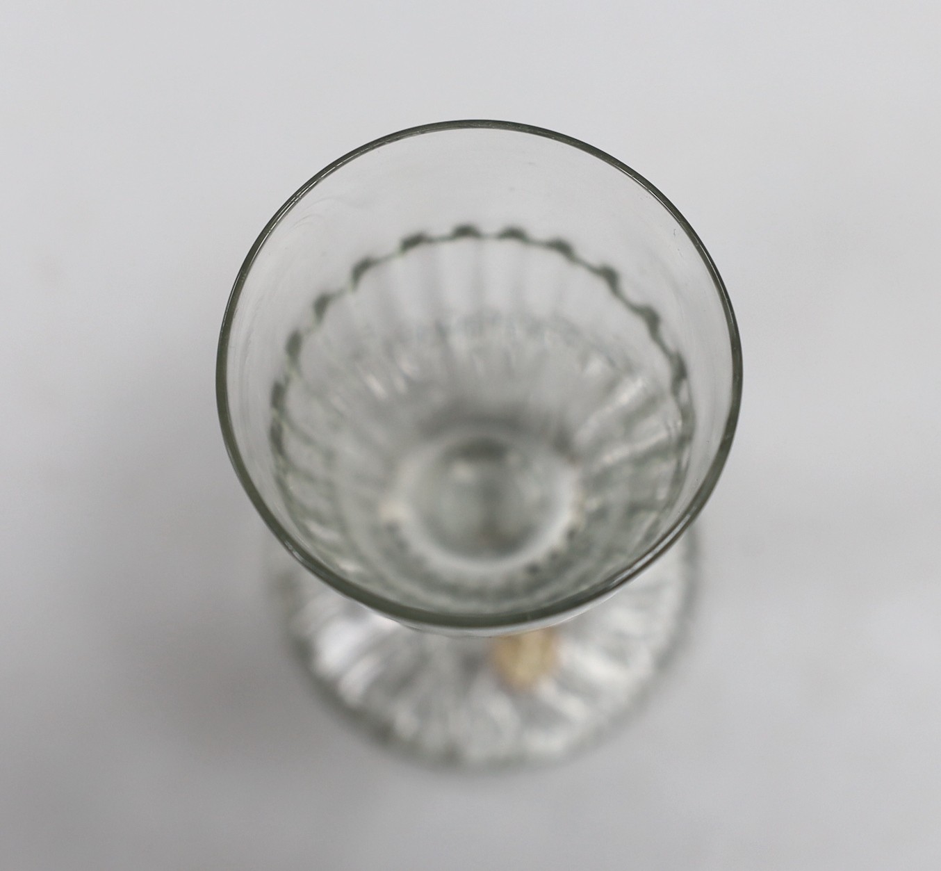 A Georgian moulded toasting glass. 9cm tall